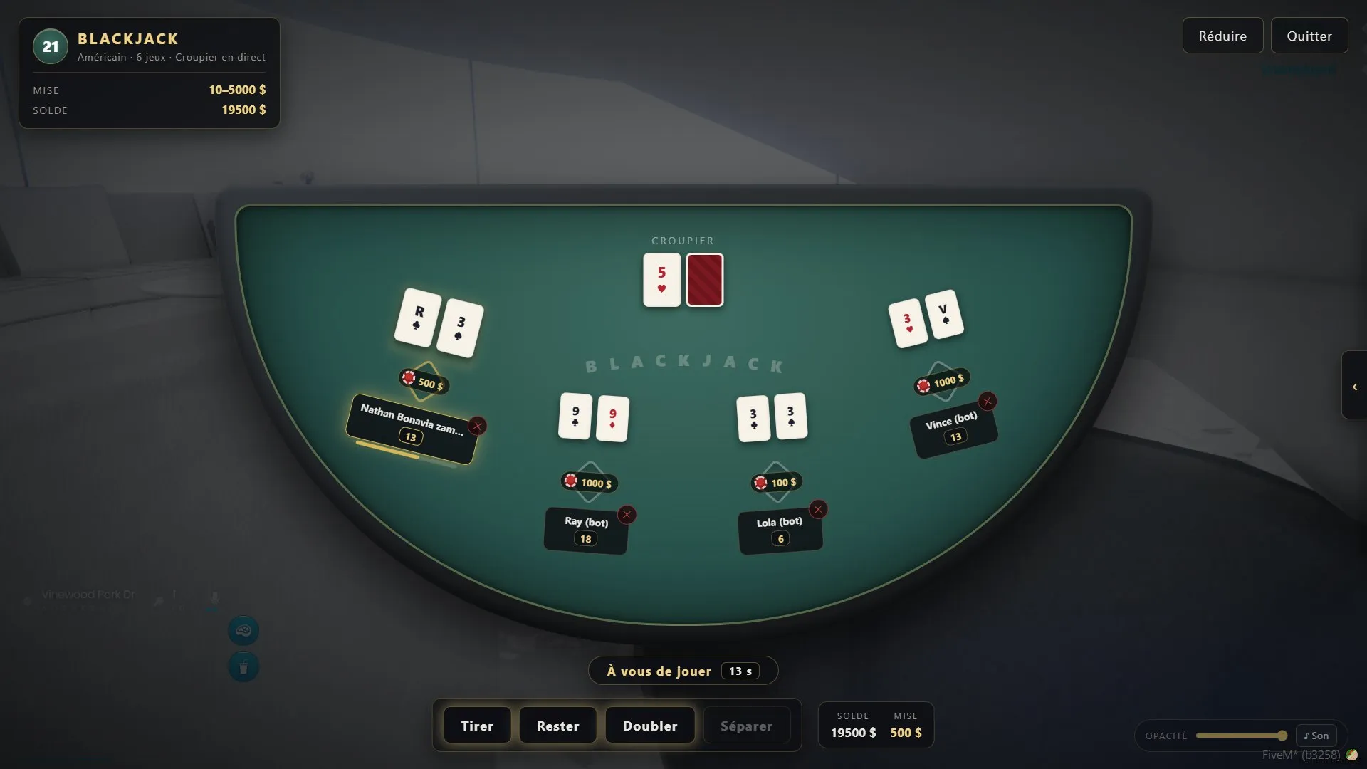 The blackjack table mid-round with fanned cards, bets and the croupier's up-card