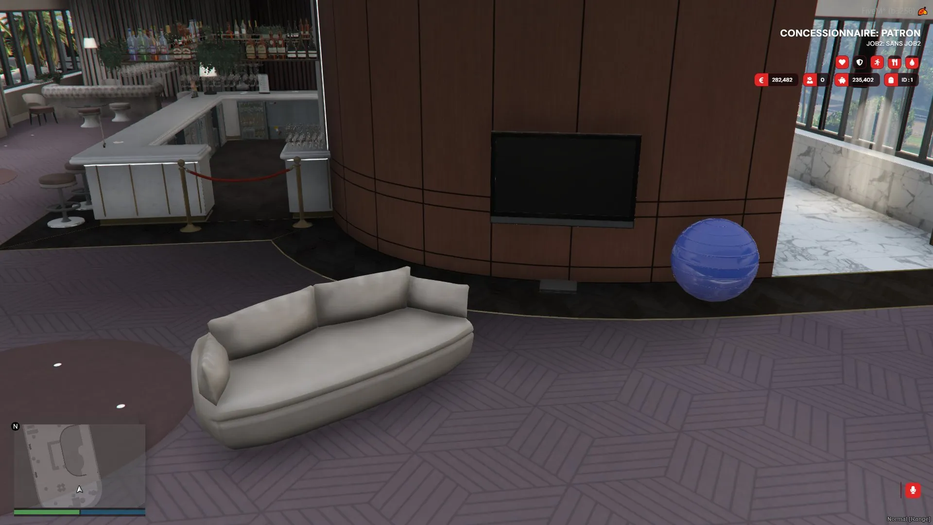 Inside the casino-house property with a sofa, a wall-mounted TV and a gym ball placed by players